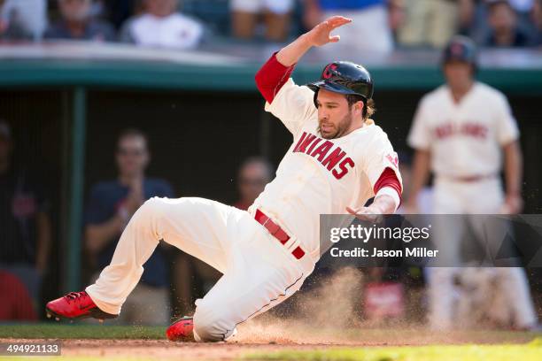 Jason Kipnis scores the go-ahead run off a single by Mike Aviles of the Cleveland Indians during the eighth inning against the Colorado Rockies at...