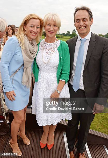 Christine Sieg, Dame Helen Mirren and Andre Konsbruck, Director of Audi UK, attend day one of the Audi Polo Challenge at Coworth Park Polo Club on...