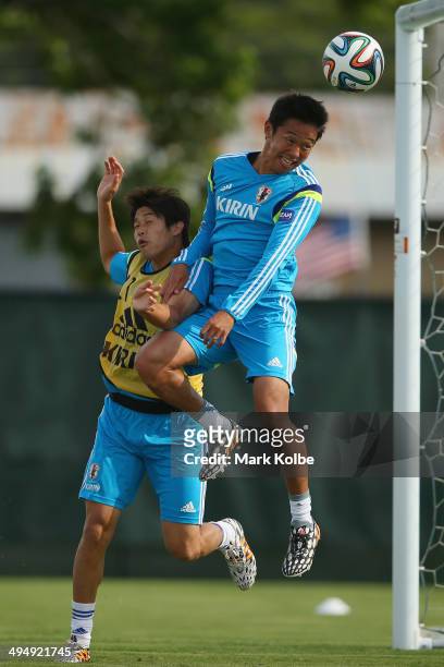 Atsuto Uchida tries to stop Hiroshi Kiyotake from heading a goal during a drill at a Japan training session at North Greenwood Recreation & Aquatic...