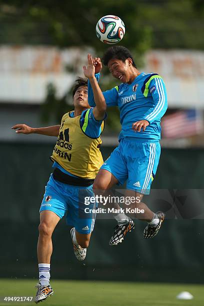 Atsuto Uchida tries to stop Hiroshi Kiyotake from heading a goal during a drill at a Japan training session at North Greenwood Recreation & Aquatic...