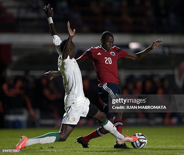 Colombia's forward Adrian Ramos vies for the ball with Senegal's defender Ibrahima Diedhiou during a friendly football match at Pedro Bidegain...
