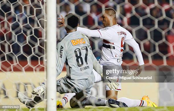 Luis Fabiano of Sao Paulo fights for the ball with goalkeeper Giovanni of Atletico MG, during a match between Sao Paulo x Atletico MG of Brasileirao...