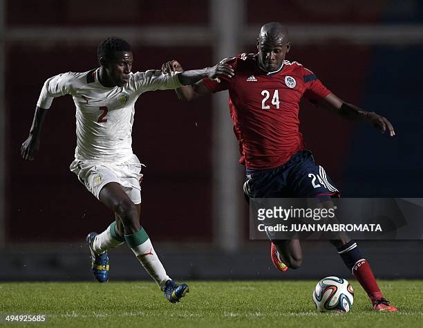Colombia's midfielder Victor Ibarbo vies for the ball with Senegal's defender Ousseynou Thioune, during a friendly football match at Pedro Bidegain...