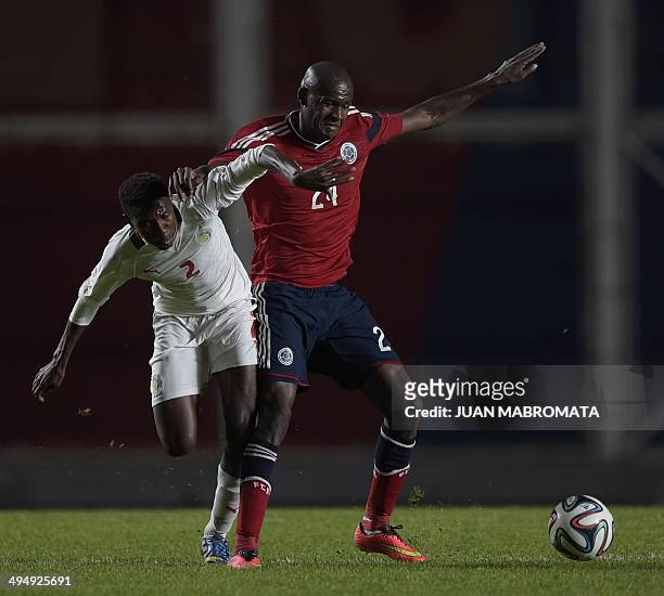 Colombia's midfielder Victor Ibarbo vies for the ball with Senegal's defender Ousseynou Thioune, during a friendly football match at Pedro Bidegain...
