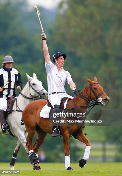 Prince Harry plays in the Audi Polo Challenge at Coworth Park Polo Club on May 31, 2014 in Ascot, England.