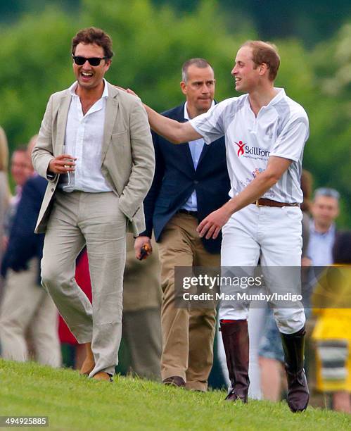 Prince William, Duke of Cambridge talks with Thomas van Straubenzee after playing in the Audi Polo Challenge at Coworth Park Polo Club on May 31,...