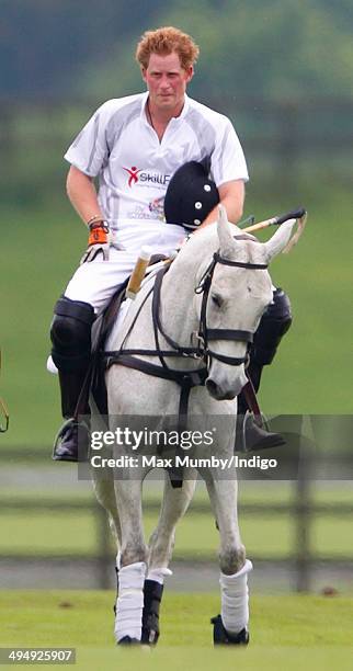 Prince Harry plays in the Audi Polo Challenge at Coworth Park Polo Club on May 31, 2014 in Ascot, England.