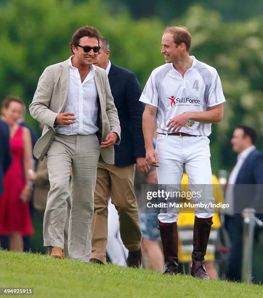 Prince William, Duke of Cambridge talks with Thomas van Straubenzee after playing in the Audi Polo Challenge at Coworth Park Polo Club on May 31,...