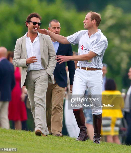 Prince William, Duke of Cambridge talks with Thomas van Straubenzee after playing in the Audi Polo Challenge at Coworth Park Polo Club on May 31,...