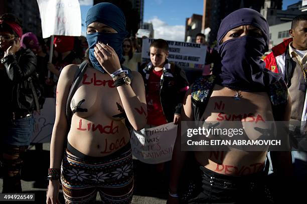 Half-naked women take part in the "Marcha de las Putas" , to protest against discrimination and violence against women in Bogota, Colombia, on May...