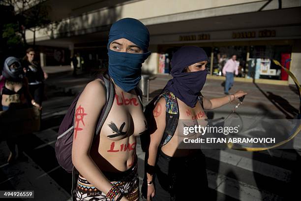Half-naked women take part in the "Marcha de las Putas" , to protest against discrimination and violence against women in Bogota, Colombia, on May...