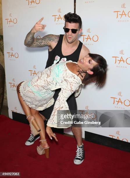 Dancer Mark Ballas and dancer/model Cheryl Burke joke around as they arrive at a birthday celebration hosted by Cheryl Burke at the Tao Beach at The...