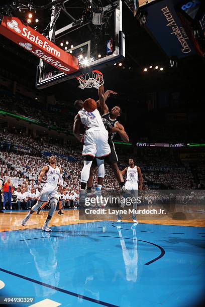 Kawhi Leonard of the San Antonio Spurs dunks against the Serge Ibaka of the Oklahoma City Thunder in Game Six of the Western Conference Finals during...