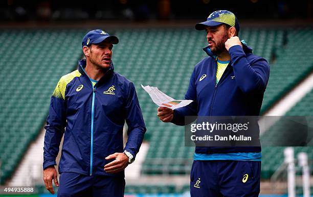 Michael Cheika, Head Coach of Australia talks with Nathan Grey, Defence Coach of Australia during the Australia Captain's Run ahead of the 2015 Rugby...