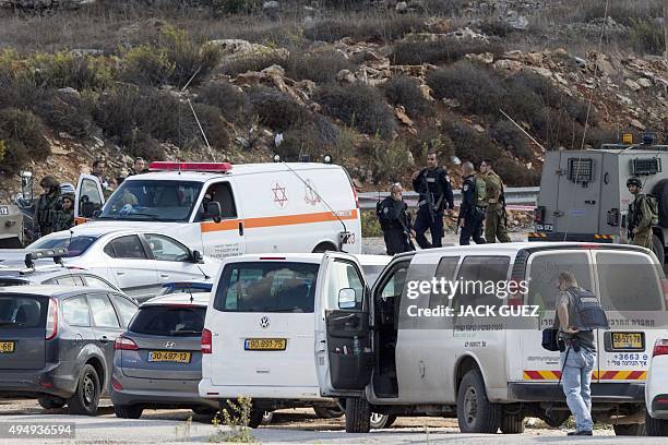 Israeli security forces gather next to the body of a Palestinian man who was shot dead after allegedly trying to stab Israeli police at the Tapuah...