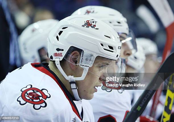 Mikkel Aagaard of the Niagara IceDogs looks on from the bench during an OHL game against the Mississauga Steelheads at the Meridian Centre on October...