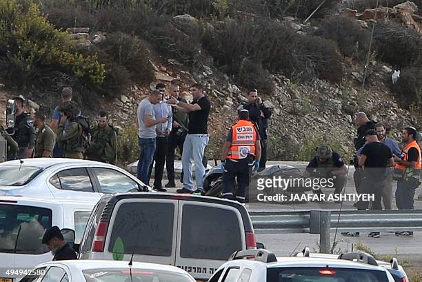 Israeli security forces inspect the motorcycle of a Palestinian man who was shot dead after allegedly trying to stab Israeli police at the Tapuah...