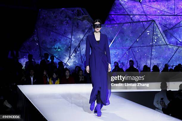 Model showcases designs on the runway at Heaven Gaia Xiong Ying High Fashion Collection show during the Mercedes-Benz China Fashion Week...