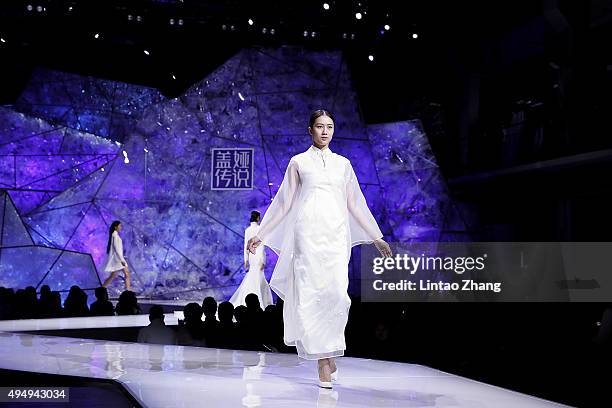 Model showcases designs on the runway at Heaven Gaia Xiong Ying High Fashion Collection show during the Mercedes-Benz China Fashion Week...