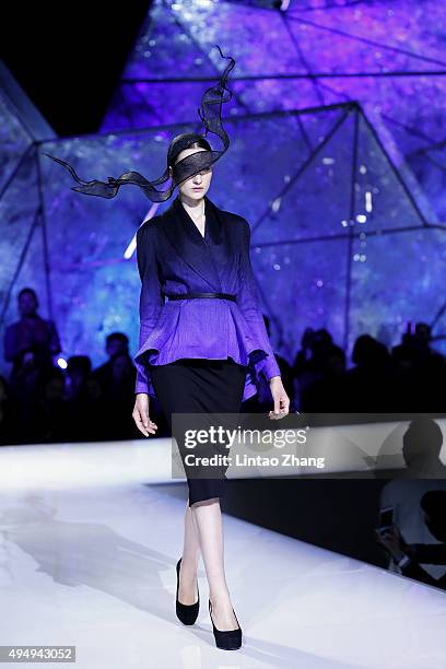 Model showcases designs on the runway at Heaven Gaia Xiong Ying High Fashion Collection show during the Mercedes-Benz China Fashion Week...