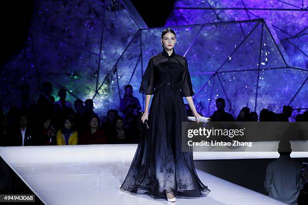 Model showcases designs on the runway at Heaven Gaia Xiong Ying High Fashion Collection show during the Mercedes-Benz China Fashion Week...