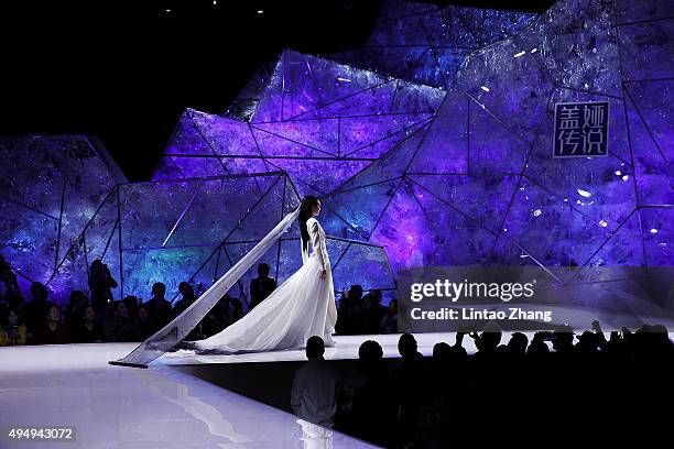 Model showcases designs on the runway at Heaven Gaia Xiong Ying High Fashion Collection show during the Mercedes-Benz China Fashion Week...