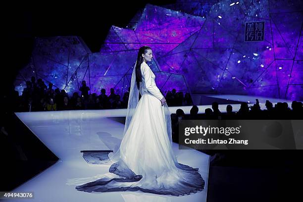 Model showcases designs on the runway at Heaven Gaia Xiong Ying High Fashion Collection show during the Mercedes-Benz China Fashion Week...