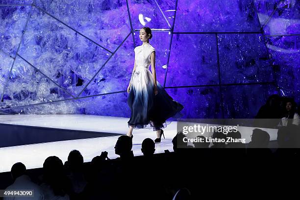 Model showcases designs on the runway at Heaven Gaia Xiong Ying High Fashion Collection show during the Mercedes-Benz China Fashion Week...