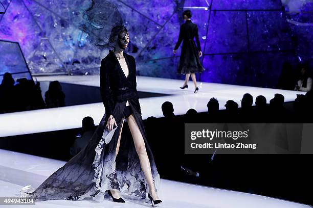 Models showcases designs on the runway at Heaven Gaia Xiong Ying High Fashion Collection show during the Mercedes-Benz China Fashion Week...