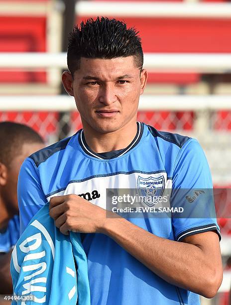 Honduras midfielder Edder Delgado changes his shirt during a practice session with his teammates in Houston, Texas, on May 31 on the eve of a World...