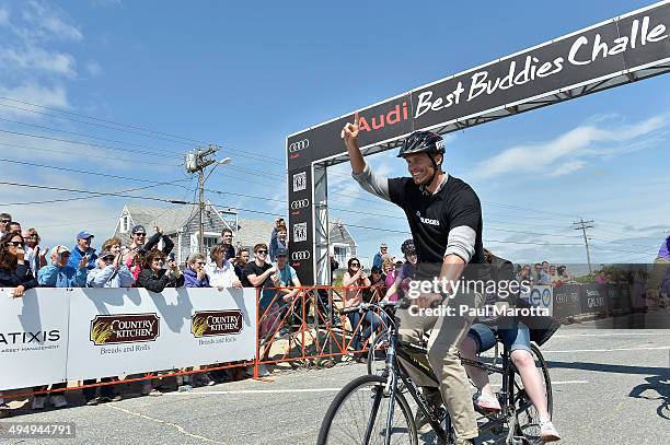 Professional football player and Best Buddies global ambassador Tom Brady, participates in the Friendship Races at the finish line and victory...