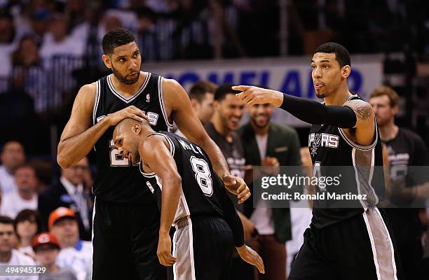 Tim Duncan, Patty Mills and Danny Green of the San Antonio Spurs celebrate a play against the Oklahoma City Thunder in the second half during Game...