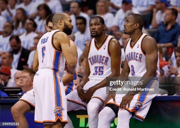 Derek Fisher, Kevin Durant and Serge Ibaka of the Oklahoma City Thunder wait to enter the game against the San Antonio Spurs in the second half...