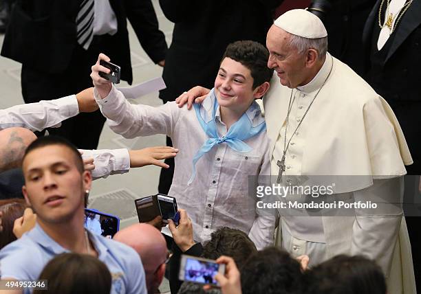 Pope Francis meeting the players and the managers of Società Sportiva Lazio in Aula Paolo VI. The Pope poses with a youg supporter. Vatican City, 7th...