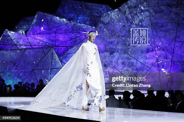 Model showcases designs on the runway at Heaven Gaia Xiong Ying High Fashion Collection show during the Mercedes-Benz China Fashion Week...