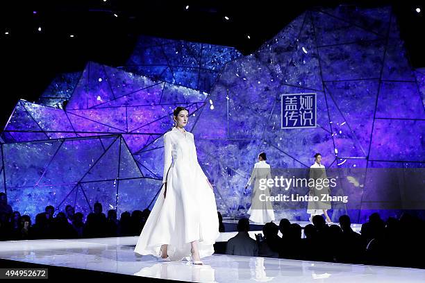 Models showcases designs on the runway at Heaven Gaia Xiong Ying High Fashion Collection show during the Mercedes-Benz China Fashion Week...