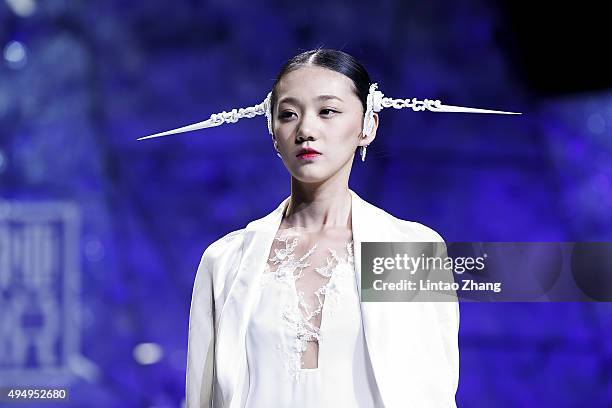Model showcases designs on the runway at Heaven Gaia Xiong Ying High Fashion Collection show during the Mercedes-Benz China Fashion Week...
