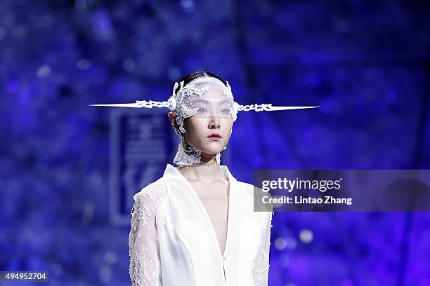 Model showcases designs on the runway at Heaven Gaia Xiong Ying High Fashion Collection show during the Mercedes-Benz China Fashion Week...