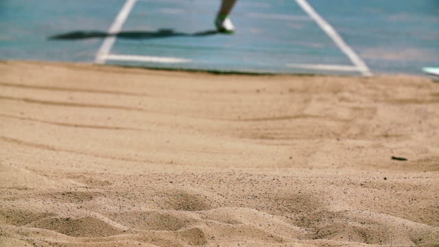 Track And Field Athlete In Slow Motion Doing Long Jump High-Res Stock Video  Footage - Getty Images