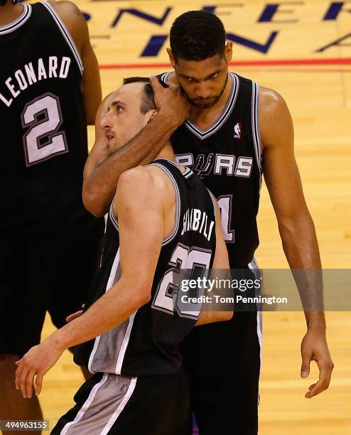 Tim Duncan of the San Antonio Spurs hugs teammate Manu Ginobili after Ginobili hit a three-point shot against the Oklahoma City Thunder in the second...