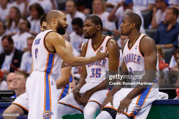 Derek Fisher, Kevin Durant and Serge Ibaka of the Oklahoma City Thunder wait to enter the game against the San Antonio Spurs in the second half...