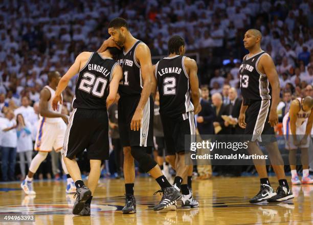 Tim Duncan of the San Antonio Spurs hugs teammate Manu Ginobili after Ginobili hit a three-point shot against the Oklahoma City Thunder in the second...