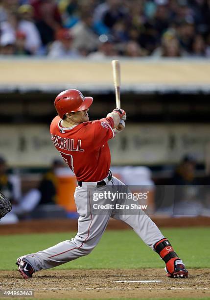 Collin Cowgill of the Los Angeles Angels of Anaheim hits a three-run home run in the fourth inning against the Oakland Athletics at O.co Coliseum on...