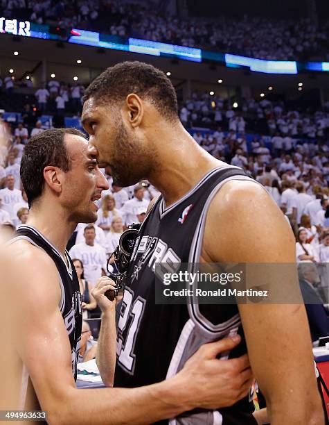 Tim Duncan of the San Antonio Spurs hugs teammate Manu Ginobili after the Spurs defeated the Oklahoma City Thunder 112-107 in overtime during Game...