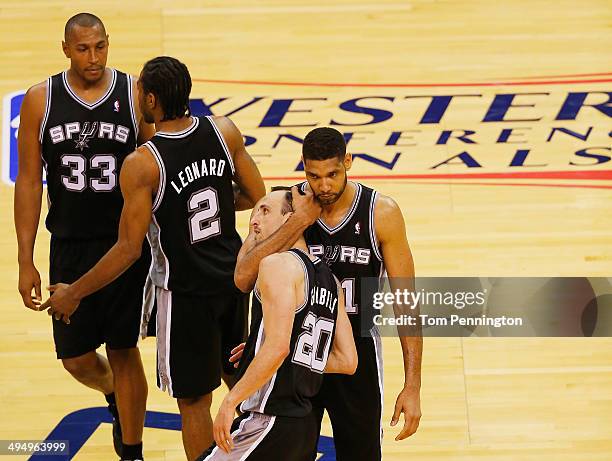 Tim Duncan of the San Antonio Spurs hugs teammate Manu Ginobili after Ginobili hit a three-point shot against the Oklahoma City Thunder in the second...