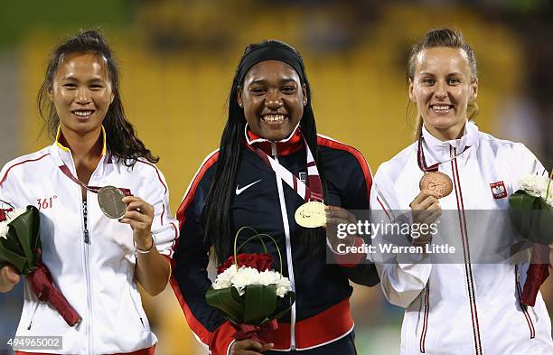 Deja Young of the United States poses with her gold medal, Yanping Wang of China silver and Alicja Fiodorow of Poland bronze for the women's 100m T47...