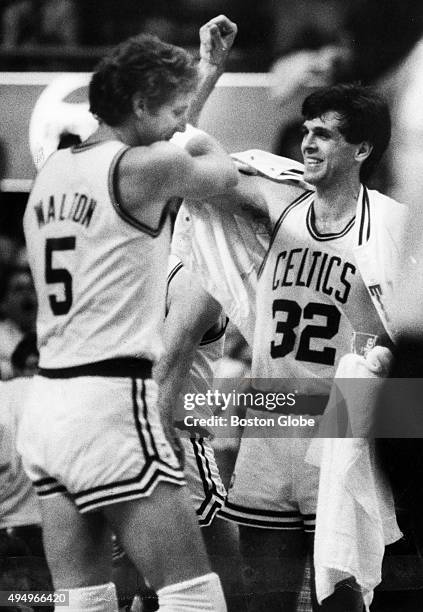 Boston Celtics players Kevin McHale, right, and Bill Walton greet each other during Game 5 of the NBA Finals against the Los Angeles Lakers at Boston...