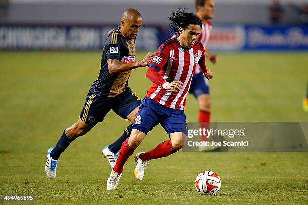 Mauro Rosales of Chivas USA defends the ball against Fabinho of Philadelphia Union at StubHub Center on May 31, 2014 in Los Angeles, California.