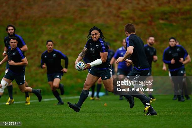 Maa Nonu of the All Blacks passes during a New Zealand All Blacks Captain's Run at Pennyhill Park on October 30, 2015 in London, United Kingdom.