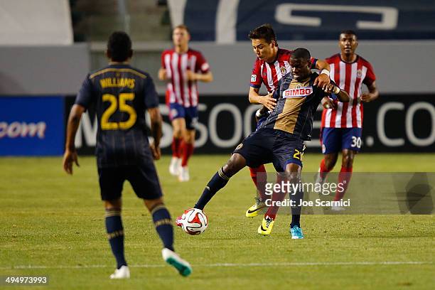 Maurice Edu of Philadelphia Union and Erick Torres of Chivas USA fight for the ball in the second half at StubHub Center on May 31, 2014 in Los...